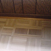 Parquet floor after retrofitting with flush mounted wood vent