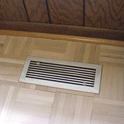 Standard metal vent in parquet floor