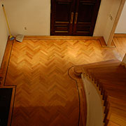 Brazilian cherry herringbone patterned hardwood floor w/curved stairway in Morganton, NC